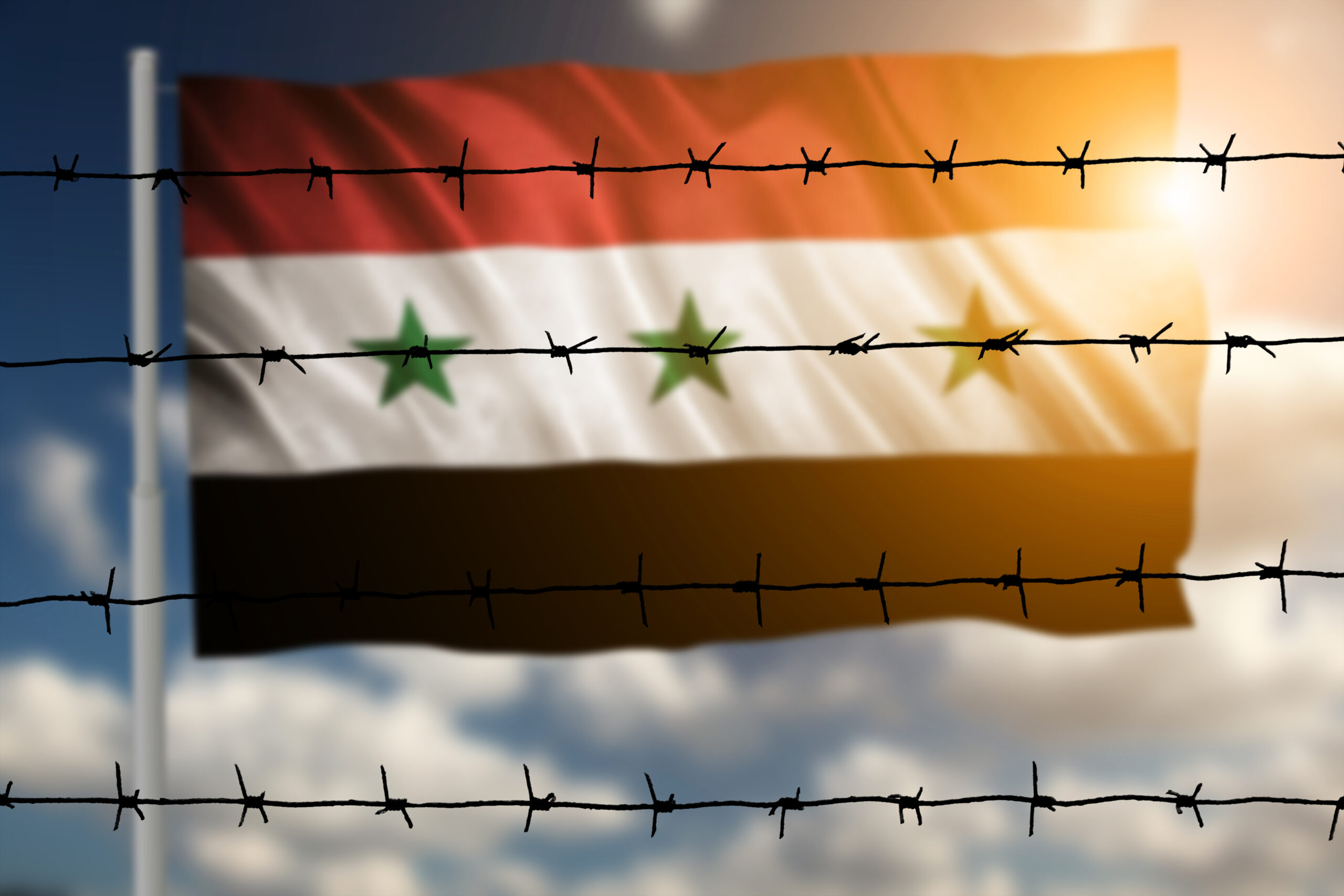 flag-with-original-proportions-flag-of-the-syria-2025-10-12-06-49-34-utc Das Symbolbild zeigt die Flagge von Syrien , die hinter Stacheldraht weht.